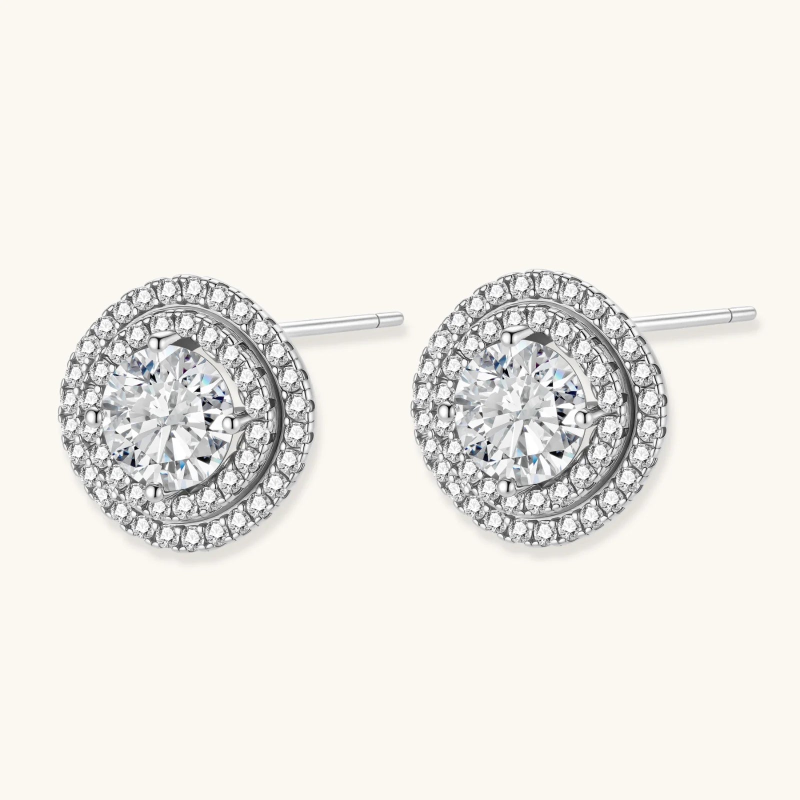 Double halo sterling silver stud earrings with brilliant round moissanite center stones and pavé crystal accents