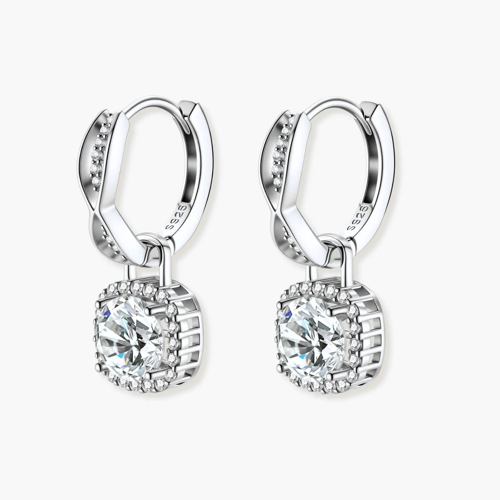 Sterling silver twisted hoop earrings with round moissanite stones in halo settings against neutral background.