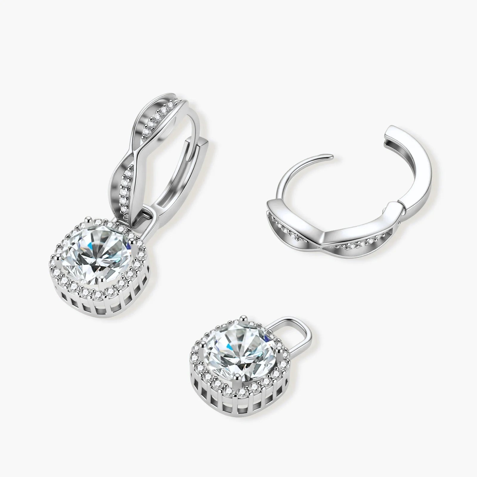 Sterling silver twisted hoop earrings with round moissanite stones in halo settings against neutral background.