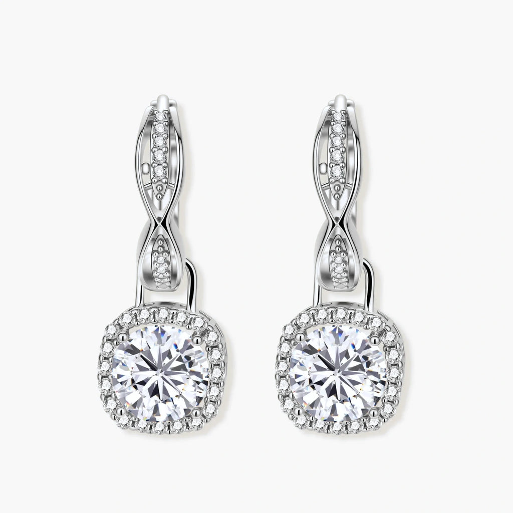 Sterling silver twisted hoop earrings with round moissanite stones in halo settings against neutral background.