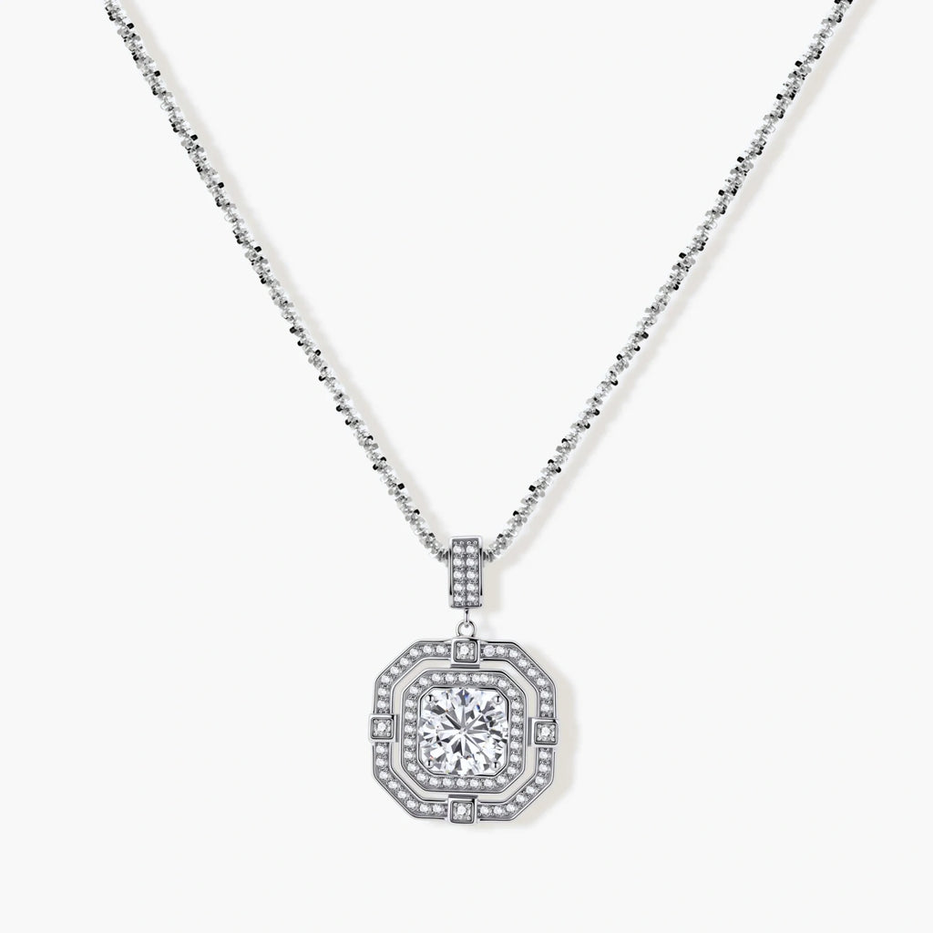 Sterling silver octagonal pendant necklace with brilliant moissanite center stone and halo setting on white background.