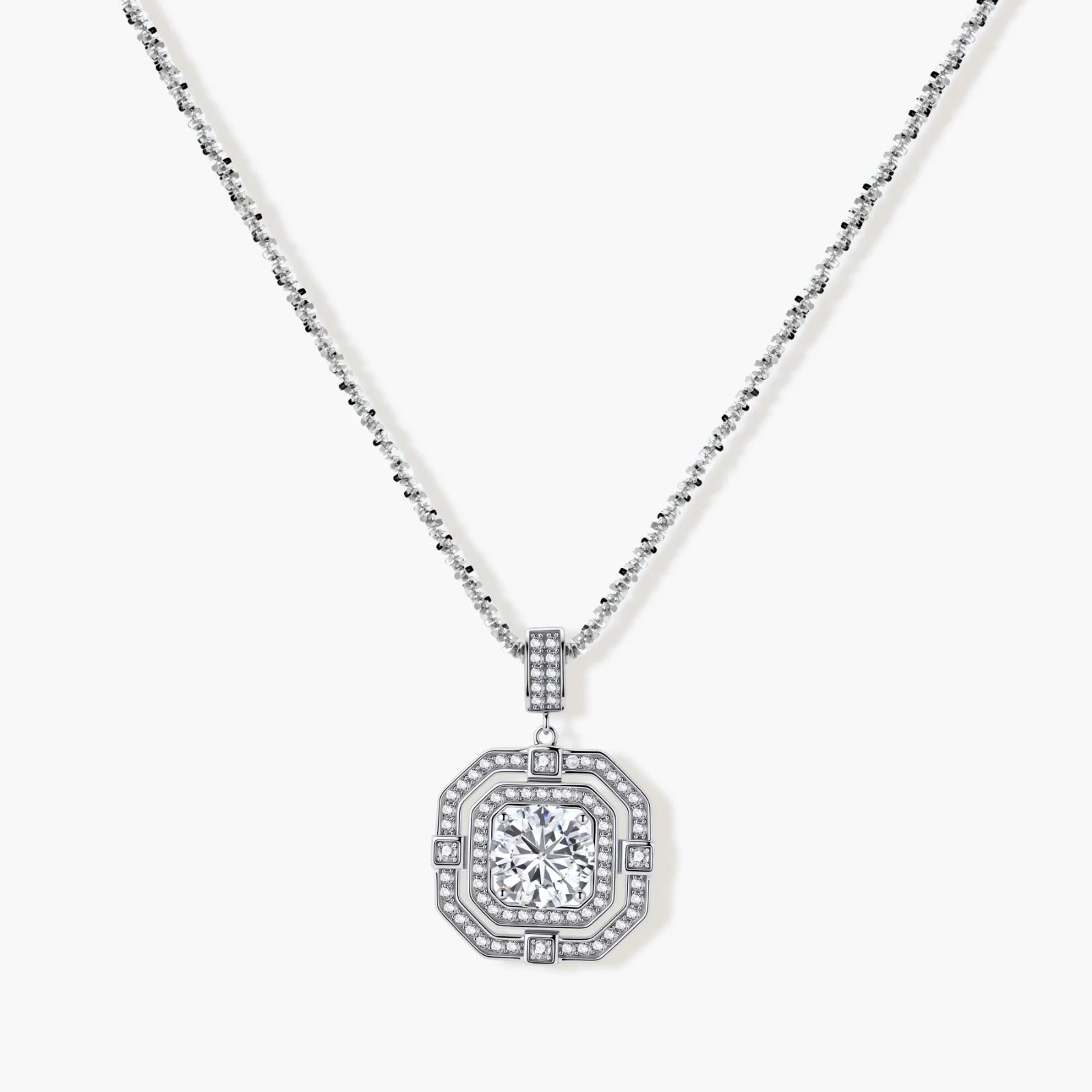 Sterling silver octagonal pendant necklace with brilliant moissanite center stone and halo setting on white background.