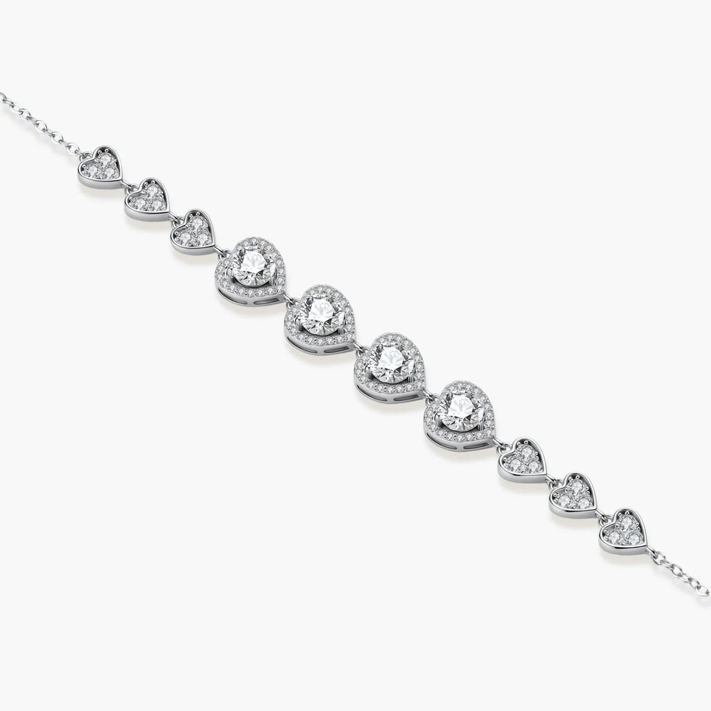 Sterling silver bracelet with graduated heart-shaped links and sparkling moissanite stones in VVS1 clarity on white background.