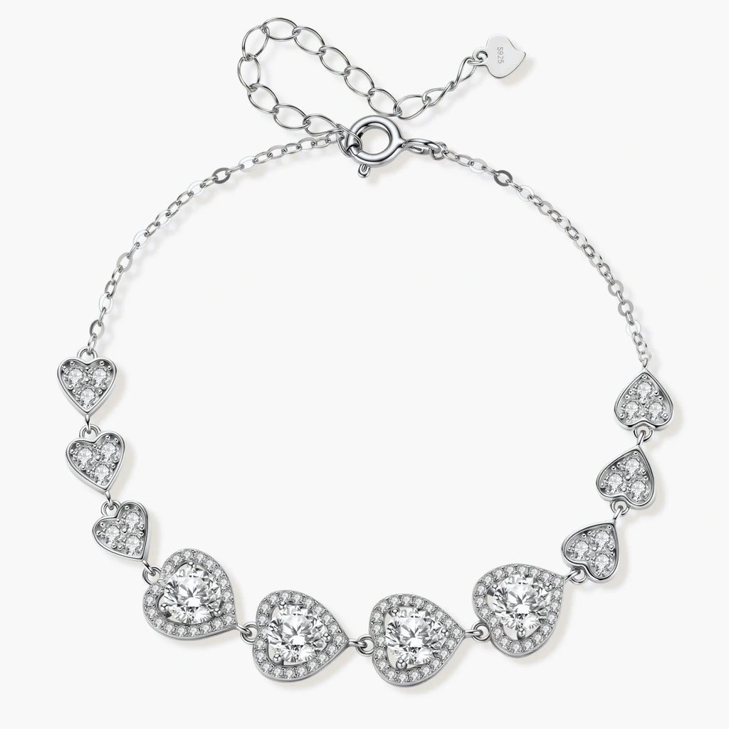 Sterling silver bracelet with graduated heart-shaped links and sparkling moissanite stones in VVS1 clarity on white background.