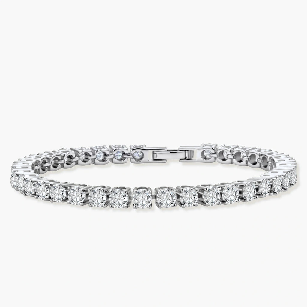 Sterling silver tennis bracelet with continuous row of brilliant moissanite stones and secure clasp closure on cream background.