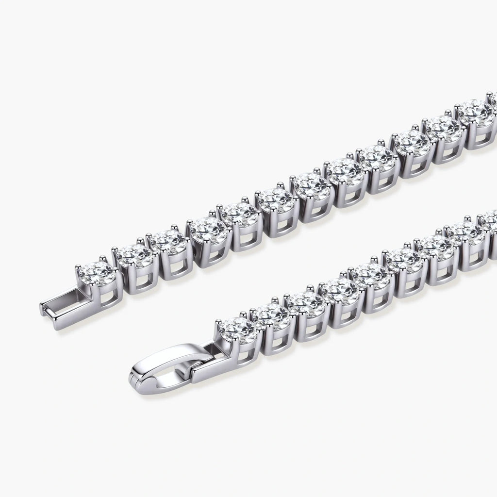 Sterling silver tennis bracelet with continuous row of brilliant moissanite stones and secure clasp closure on cream background.