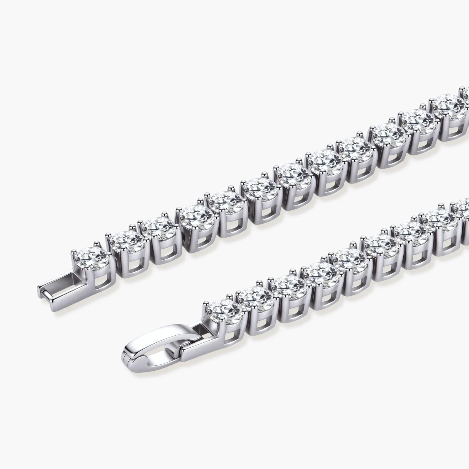 Sterling silver tennis bracelet with continuous row of brilliant moissanite stones and secure clasp closure on cream background.