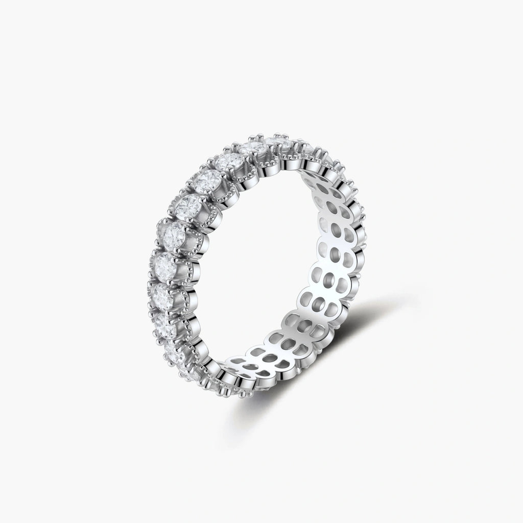 Sterling silver eternity ring with continuous row of brilliant moissanite stones in scalloped crown setting with milgrain detail