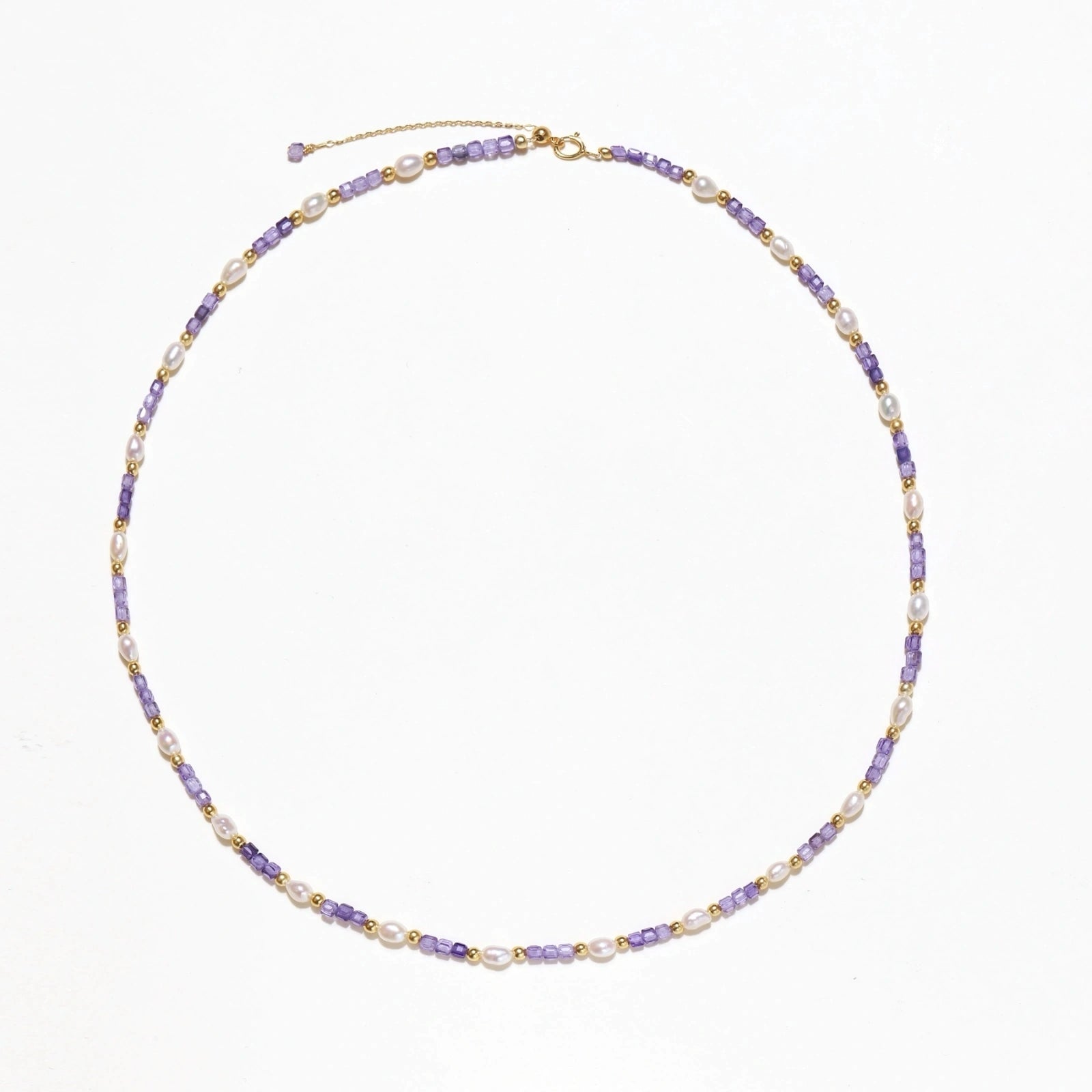 Delicate 18K gold vermeil necklace with alternating lavender zirconia beads and white freshwater pearls on cream background
