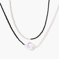 Double-strand necklace with black faceted quartz and white pearls featuring an oversized baroque pearl centerpiece