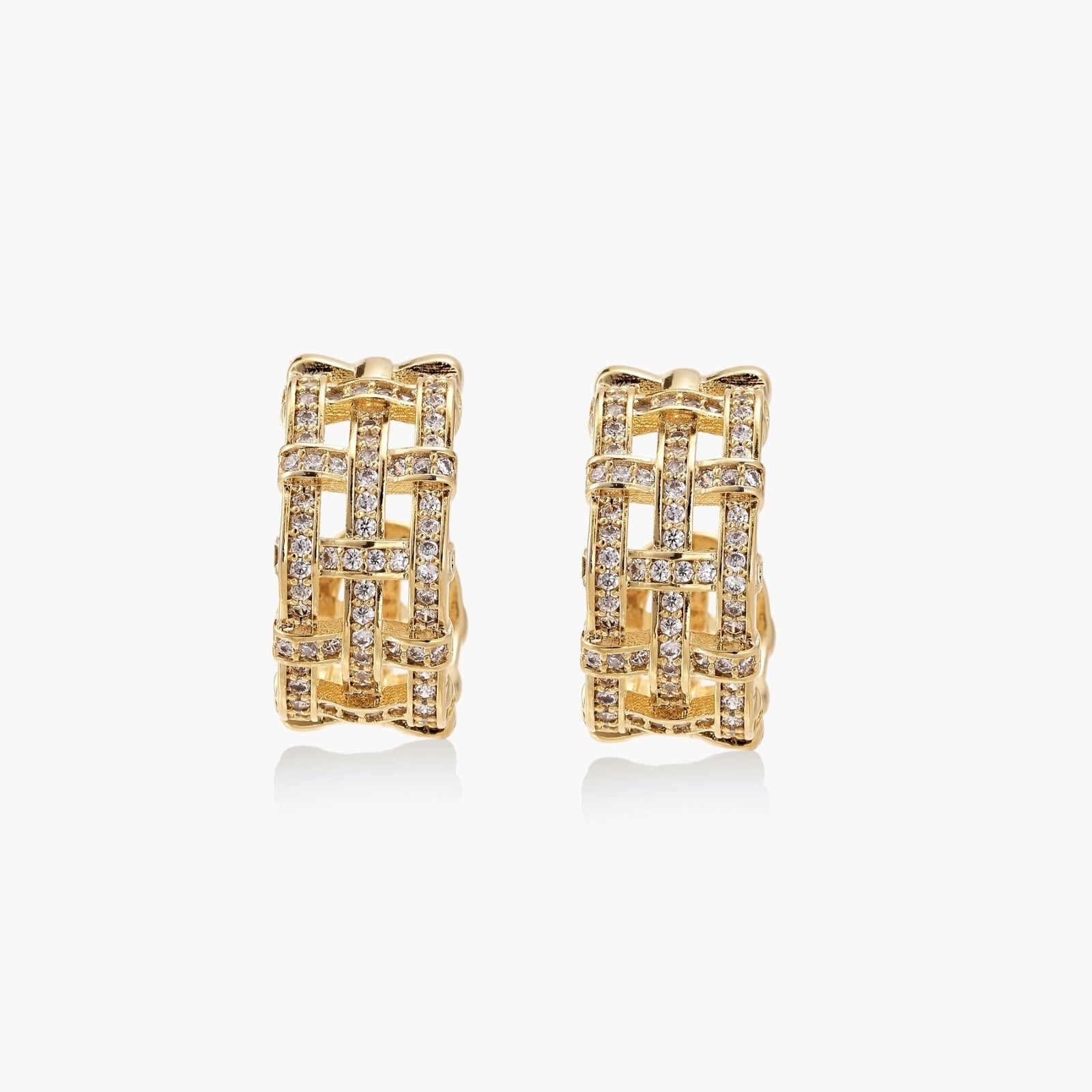 Gold-plated geometric hoop earrings with basket-weave lattice design and pavé crystal accents on cream background