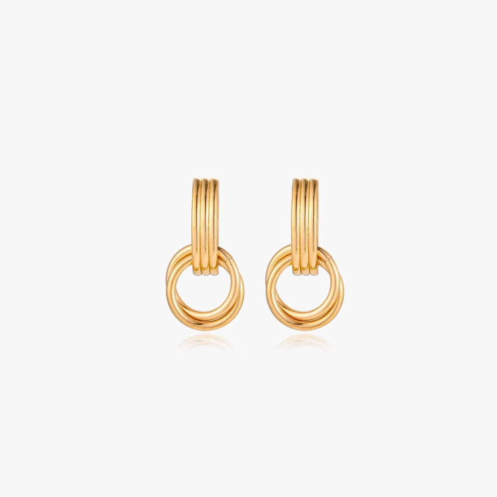 Gold stud earrings with vertical ridged bar connecting to triple interlocking circular rings on white background