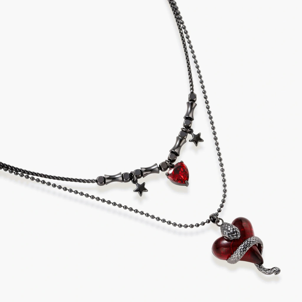 Gothic jewelry set with asymmetrical black metal earrings featuring red crescent moons, stars, and layered necklaces with heart pendants