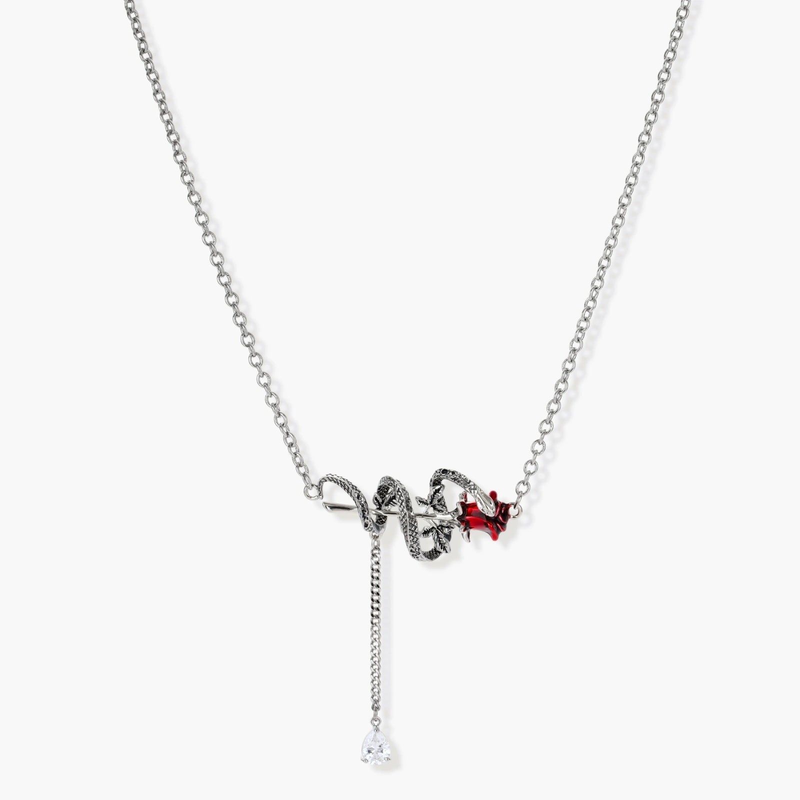 Gothic jewelry set with silver snake designs holding red enamel roses, featuring detailed leaf stems on cream background