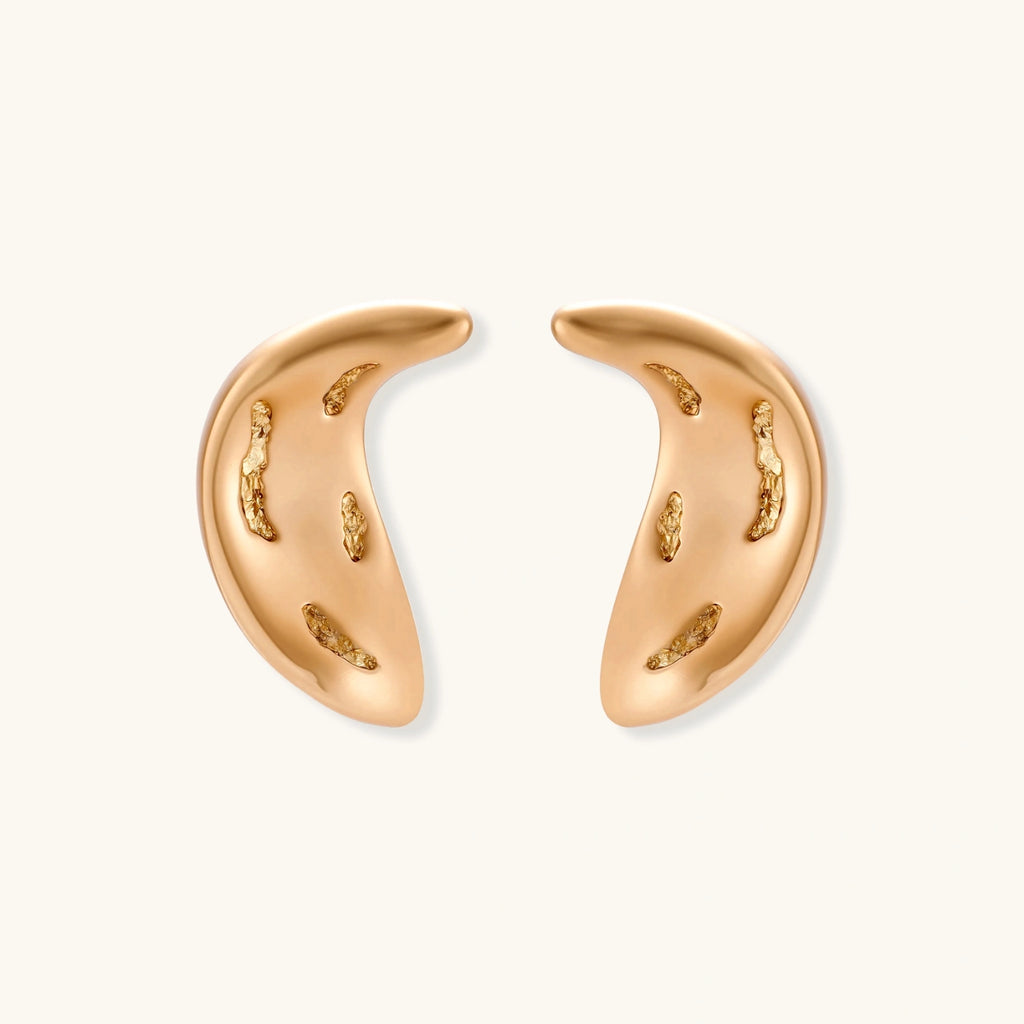 Gold-toned crescent moon pendant with textured surface on black adjustable cord, displayed with matching crescent earrings