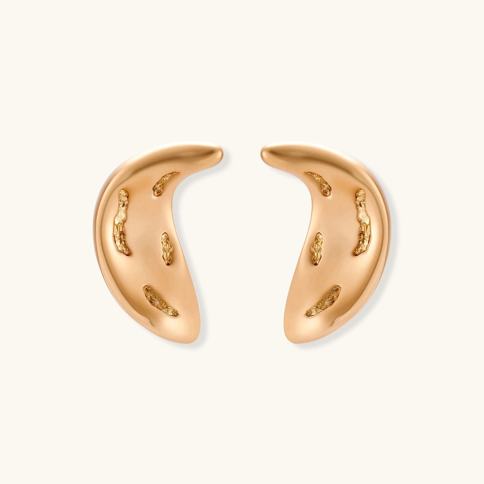 Gold-toned crescent moon pendant with textured surface on black adjustable cord, displayed with matching crescent earrings