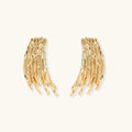 Flowing fringe earrings with cascading curved metal elements in gold tone, showing dimensional movement and sculptural design.