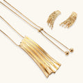 Gold-toned cascade jewelry set with flowing textured strands, featuring drop earrings and matching pendant necklace