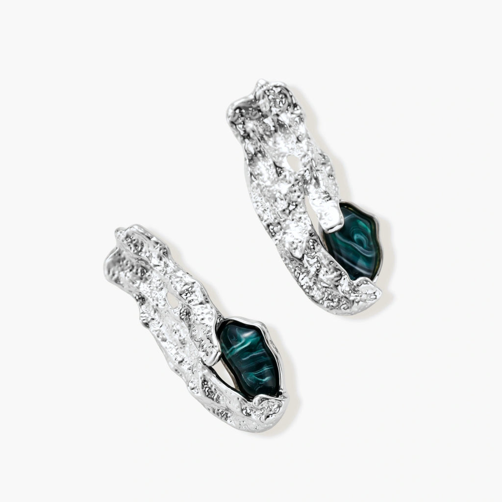Organic-shaped stud earrings with hammered silver finish and green malachite-pattern resin stones on white background.