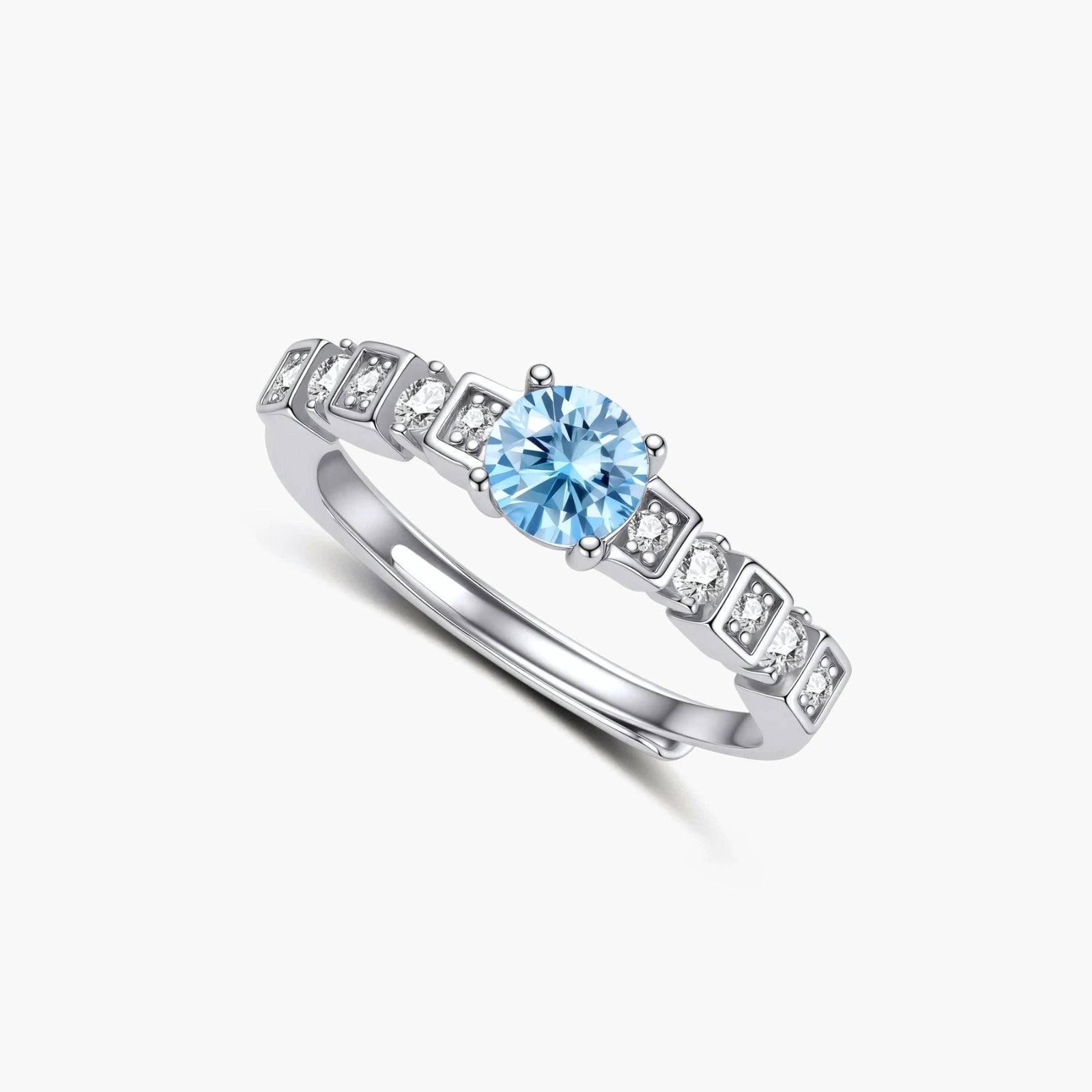 Geometric sterling silver ring with light blue moissanite center stone and square diamond accents on white background