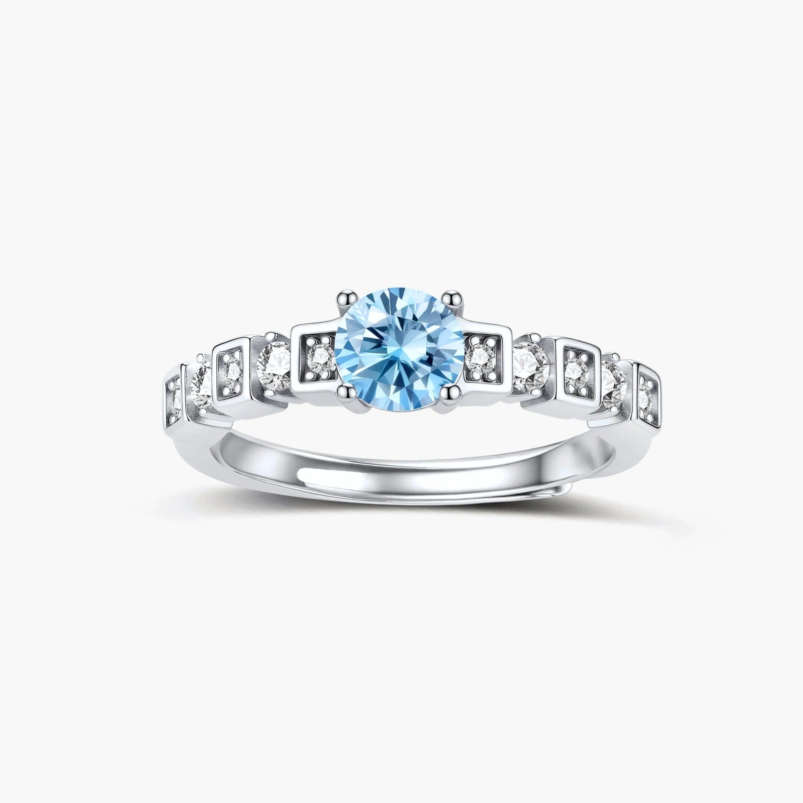 Geometric sterling silver ring with light blue moissanite center stone and square diamond accents on white background
