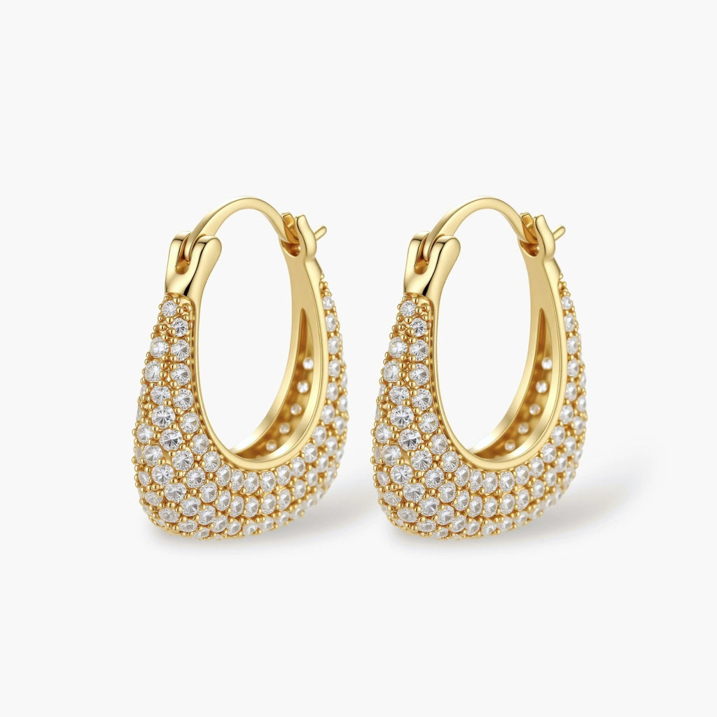 Gold-plated hoop earrings fully covered in sparkling zircon crystals with hinged closure on neutral background