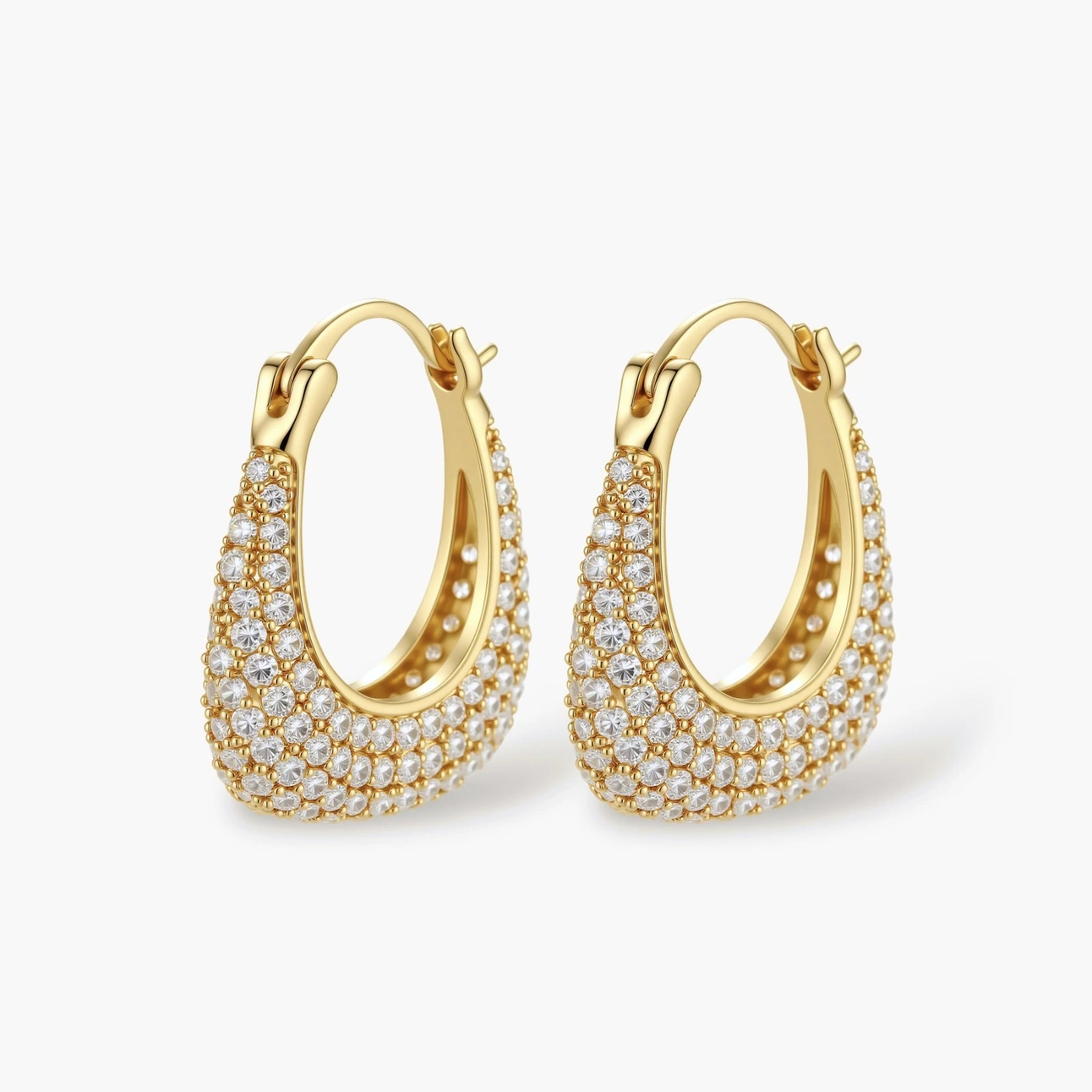 Gold-plated hoop earrings fully covered in sparkling zircon crystals with hinged closure on neutral background