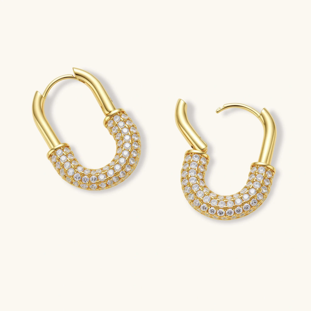 Gold-plated huggie hoop earrings with pavé zirconia stones covering the bottom curve, shown in open and closed positions.