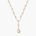 Long gold-plated necklace with alternating freshwater pearls and crystal bezels, featuring a large baroque pearl pendant
