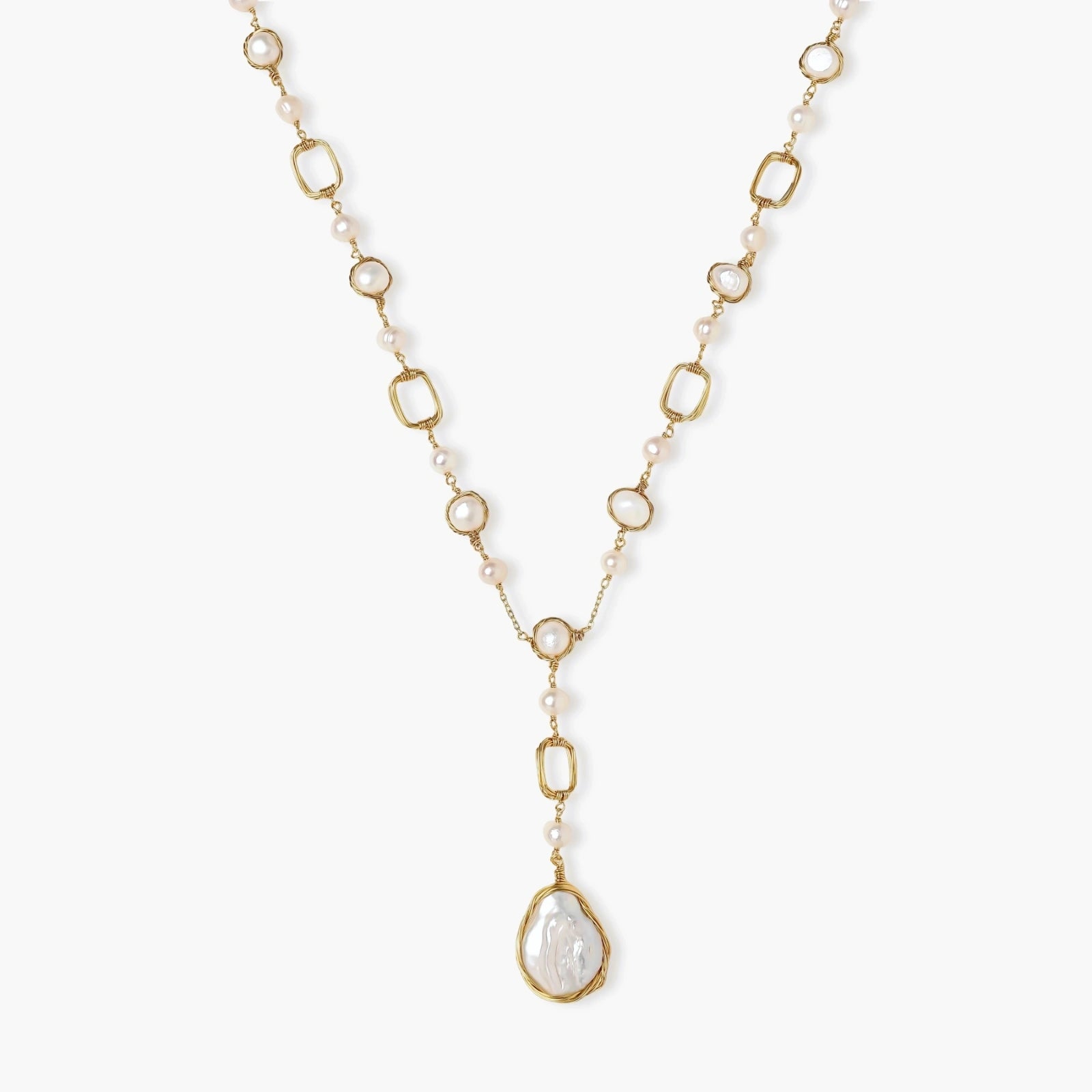 Long gold-plated necklace with alternating freshwater pearls and crystal bezels, featuring a large baroque pearl pendant