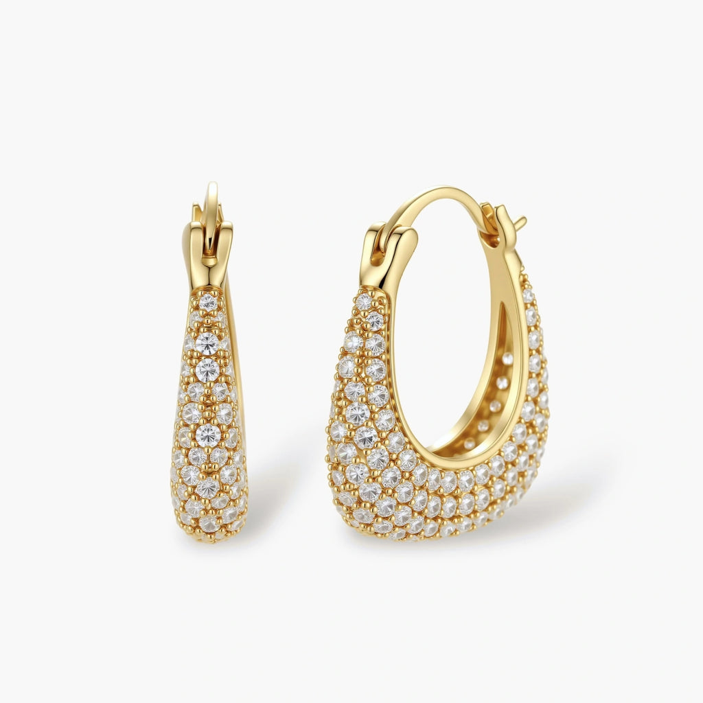 Gold-plated hoop earrings fully covered in sparkling zircon crystals with hinged closure on neutral background