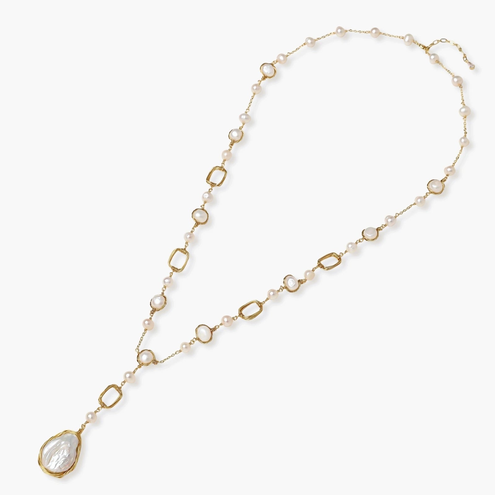 Long gold-plated necklace with alternating freshwater pearls and crystal bezels, featuring a large baroque pearl pendant
